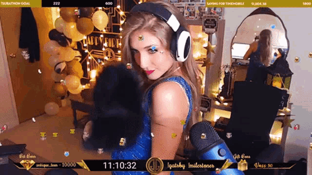 a woman wearing headphones and a blue dress is on a stream