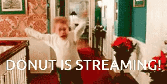 a person is standing in a living room with the words donut is streaming behind them