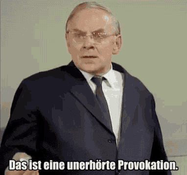 a man in a suit and tie is saying " das ist eine unerhörte provokation "
