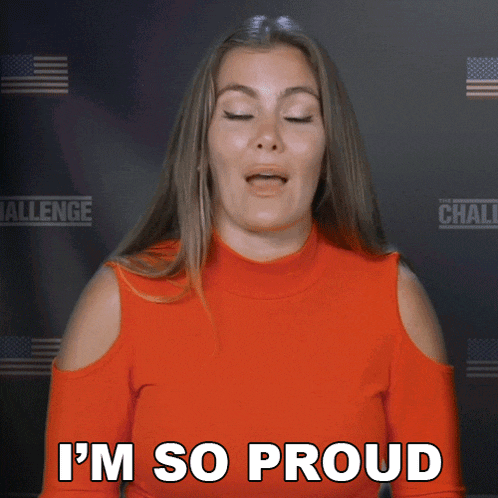 a woman says i 'm so proud in front of a challenge sign