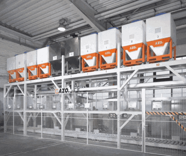 a warehouse with a fence and a sign that says azo on it
