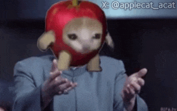 a man in a suit has an apple on his head and the hashtag applecat_acat