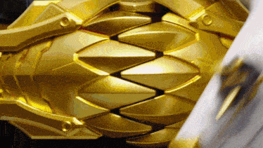 a close up of a gold object that looks like a flower