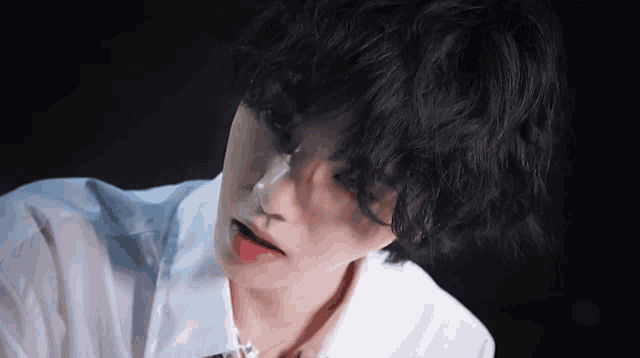 a close up of a person with a white shirt on