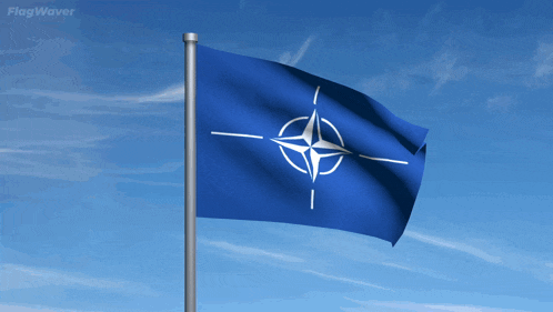 a blue flag with a white star in the middle is flying in the wind