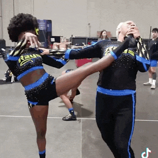 two cheerleaders wearing black and blue uniforms with the word rays on the front