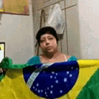 a woman is holding a brazilian flag in her hands .