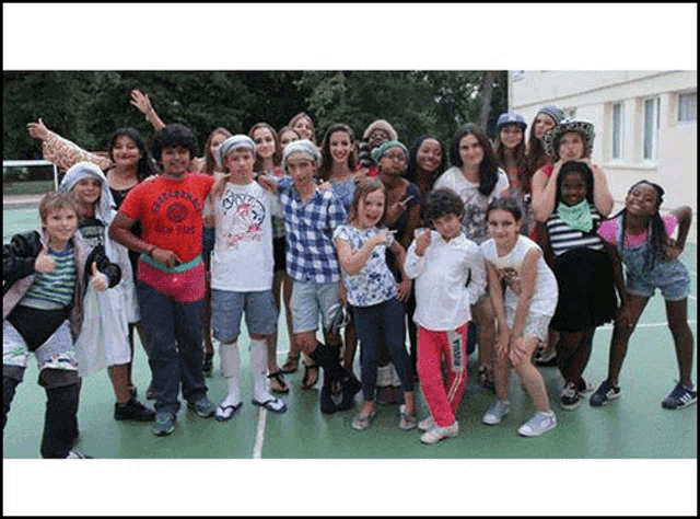 a group of young people posing for a picture on a court .