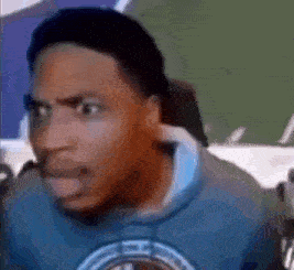 a man wearing a blue sweatshirt is making a funny face .