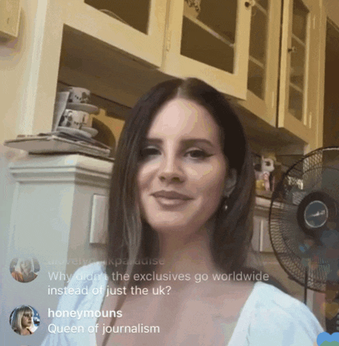 a woman in a kitchen with a fan and the words honeymounts queen of journalism on the bottom right