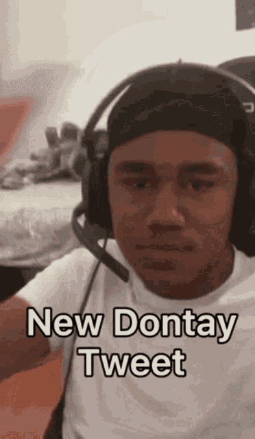 a man wearing headphones says " new dontay tweet " on the bottom