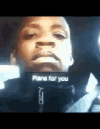 a man is wearing a black jacket that says plans for you