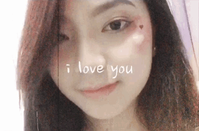 a close up of a woman 's face with i love you written on her face