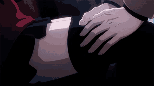 a close up of a person 's hand on another person 's thigh
