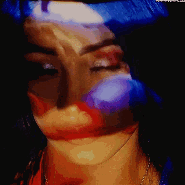 a close up of a woman 's face with the next thing written on the bottom right corner
