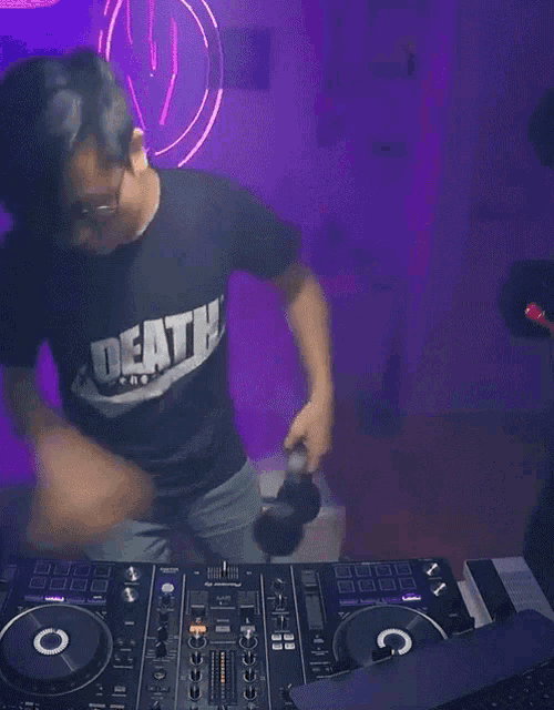 a man wearing a shirt that says death is playing music