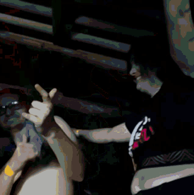 a blurry picture of a person holding a microphone and giving a thumbs up