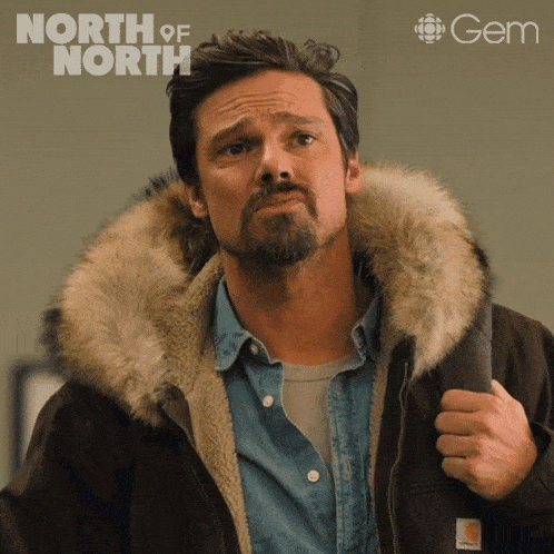 a man wearing a fur hooded jacket with the words north of north written on the bottom