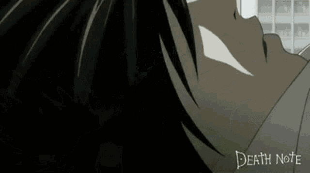 a close up of a person 's face with the word death note on the bottom .