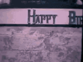 a sign on a wall that says `` happy birthday '' .
