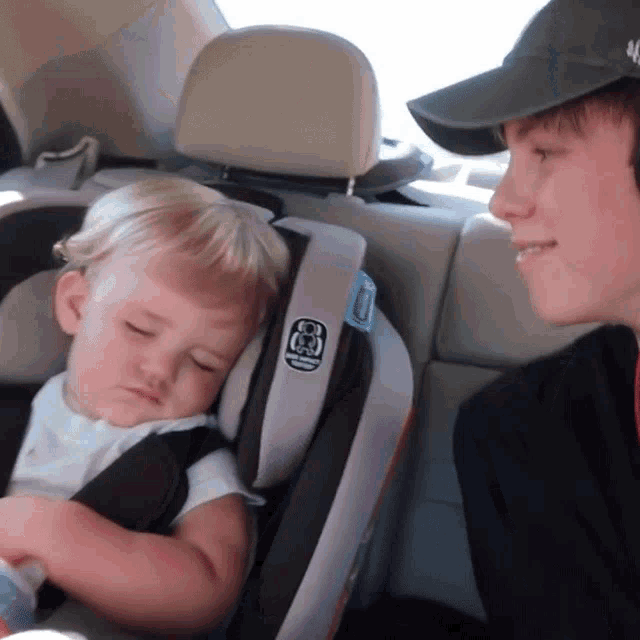 a baby is sleeping in a car seat that says ' safety 1st ' on the side