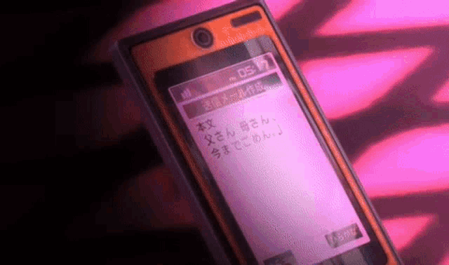a close up of a cell phone with a pink background