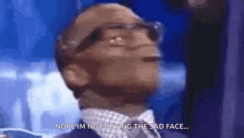 a man wearing glasses and a suit is saying `` nope i 'm not buying the sad face '' .