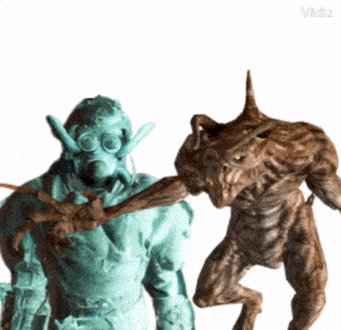 a statue of a man in a gas mask standing next to a statue of a monster