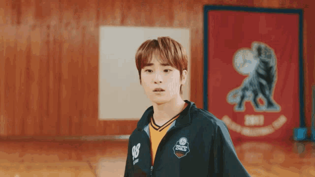 a young man wearing a jacket that says ' basketball ' on it