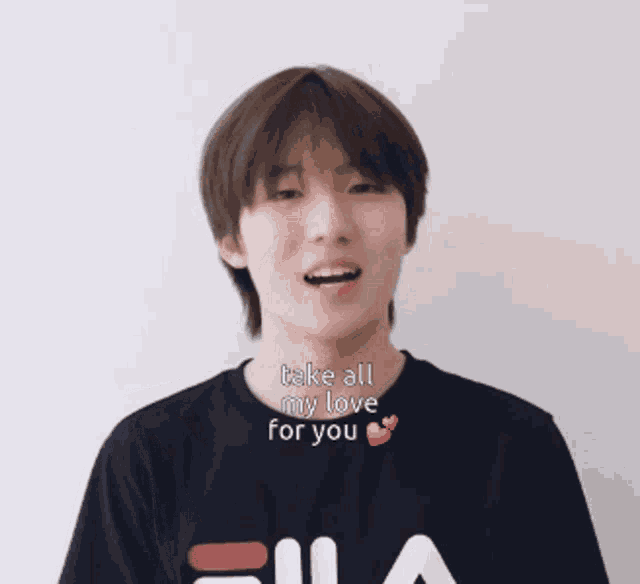 a young man wearing a fila t-shirt says take all my love for you