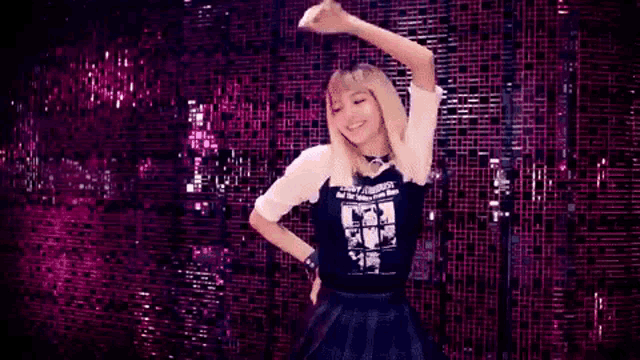 a woman is dancing in front of a purple wall in a room .