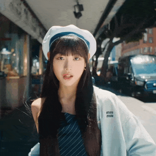 a woman wearing a beret and a miu jacket