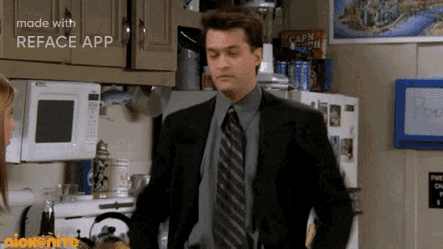 a man in a suit and tie is standing in a kitchen with a sign that says reface app in the corner