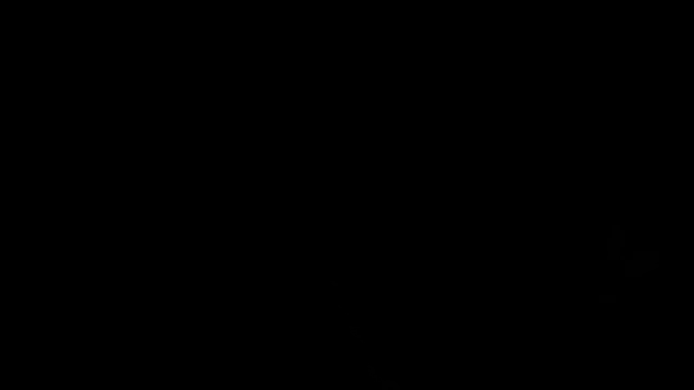 a man in a mask is holding a light bulb