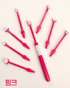 a bunch of pink toothbrushes on a white surface with chinese writing