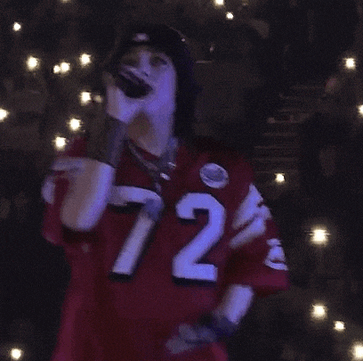 a girl wearing a red jersey with the number 72 on it