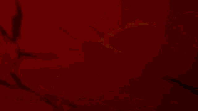 a cartoon drawing of a monster with red and white stripes on it