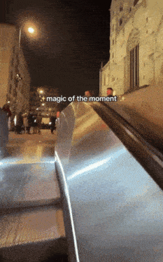 a picture of an escalator with the words magic of the moment above it