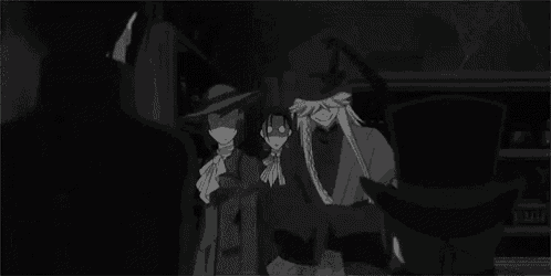 a group of people standing next to each other in a dark room .