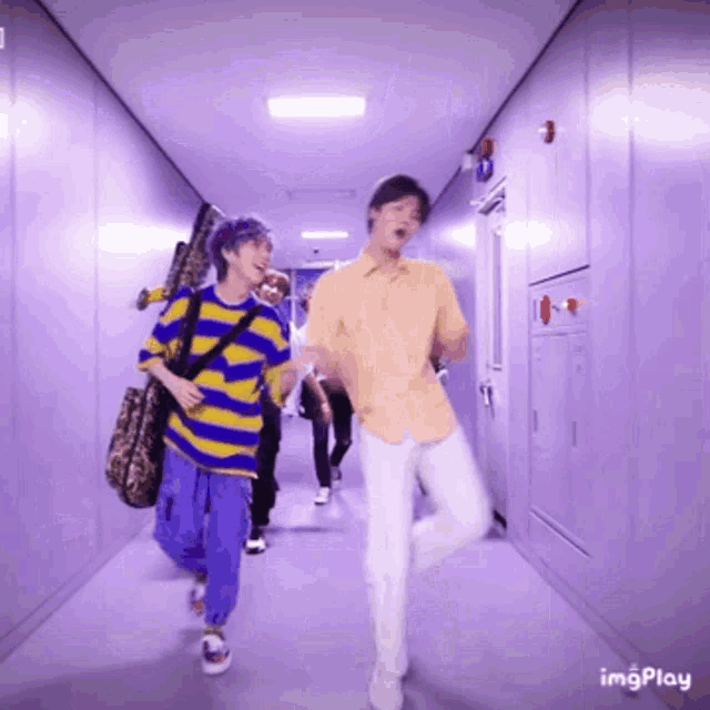 a group of young men are dancing in a hallway with the words imgplay visible