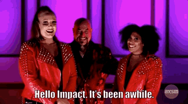 a man and two women in red jackets are standing next to each other with the words hello impact it 's been awhile