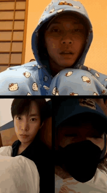 a man wearing a blue hello kitty hoodie is laying on a bed