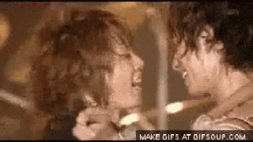 a couple of women are standing next to each other and looking at each other in a room .