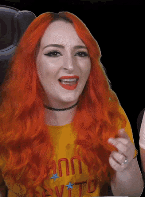 a woman with red hair is wearing a yellow shirt that says " annie vito "
