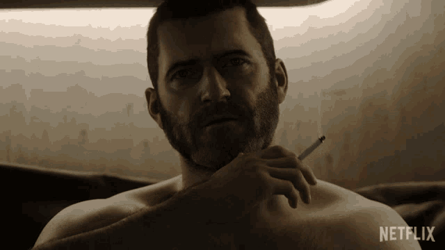 a man with a beard is smoking a cigarette in a netflix ad