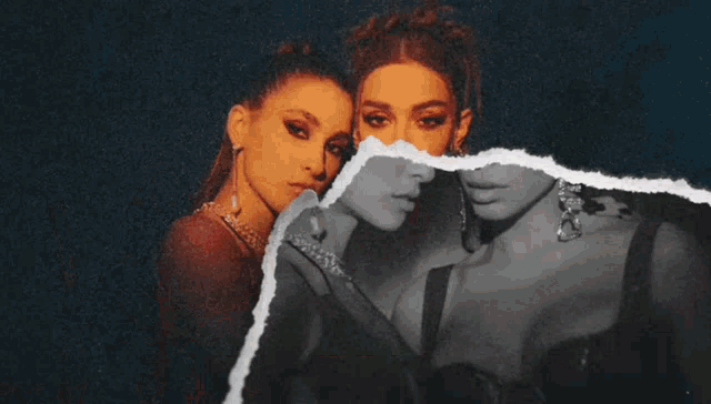 two women are standing next to each other and one of them has a gun