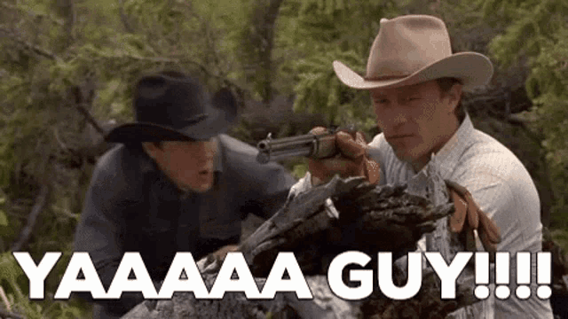 a man in a cowboy hat is pointing a gun at another man in a cowboy hat .