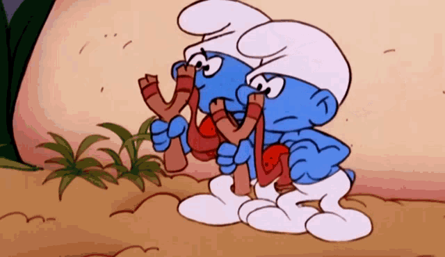 two smurfs are holding slingshots in their hands in a cartoon