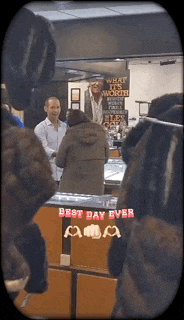 a group of people standing in front of a counter that says best day ever on it