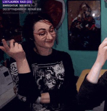 a woman wearing glasses and a black shirt with a picture of a woman on it